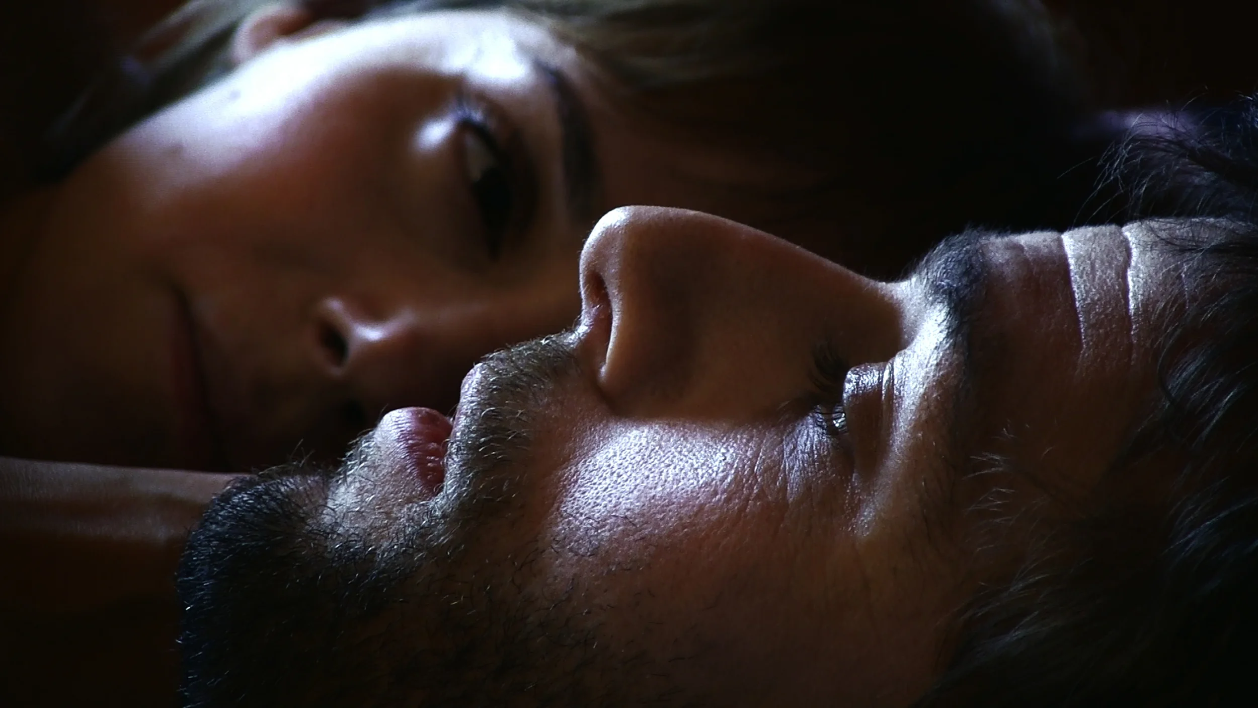 Mireia lays beside a partner. Although the film's participants appear under their real names, their onscreen gatherings and relationships have all been staged and largely improvised for Guerín’s camera.