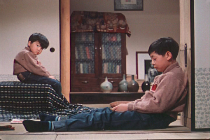 Isamu (Masahiko Shimazu, left) and his brother Minoru (Koji Shidara) sulk after their latest appeals for a family TV are rebuffed.