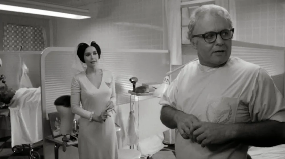 Mr. Joyboy (Rod Steiger) and his assistant Aimée (Anjanette Comer).