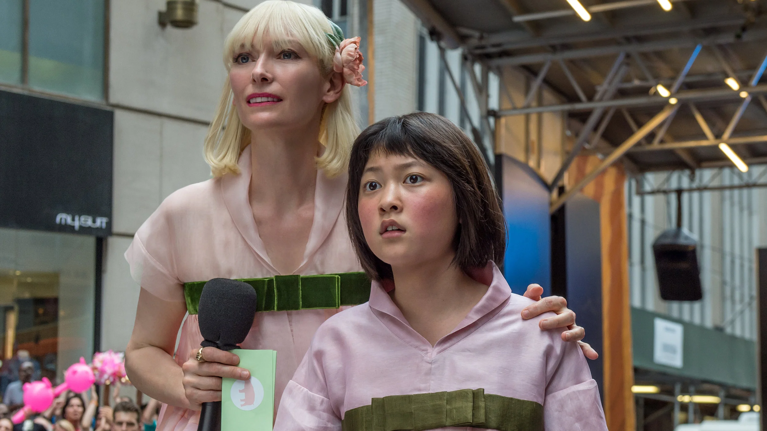 Mirando Corporation head Lucy Mirando (Tilda Swinton) with Mija at a public presentation in New York.