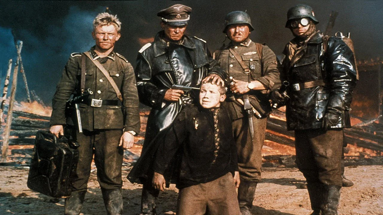 The young partisan Florya (Aleksei Kravchenko) forced at gunpoint for a photo by the German invaders in Elem Klimov's searing Come and See .