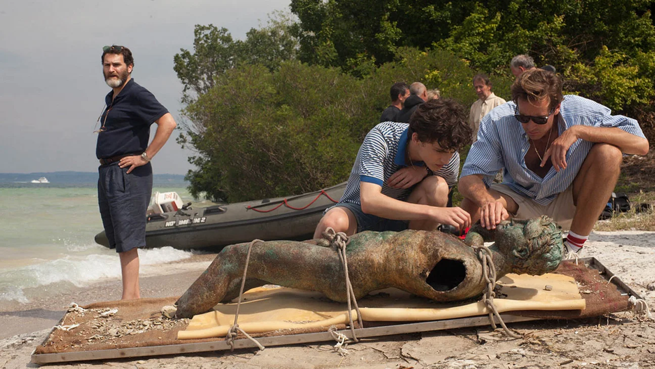 Teenager Elio (Timothée Chalamet, center) and American doctoral student Oliver (Armie Hammer) inspect a Greco-Roman sculpture discovered undersea by Elio’s professor father Mr. Perlman (Michael Stuhlbarg).