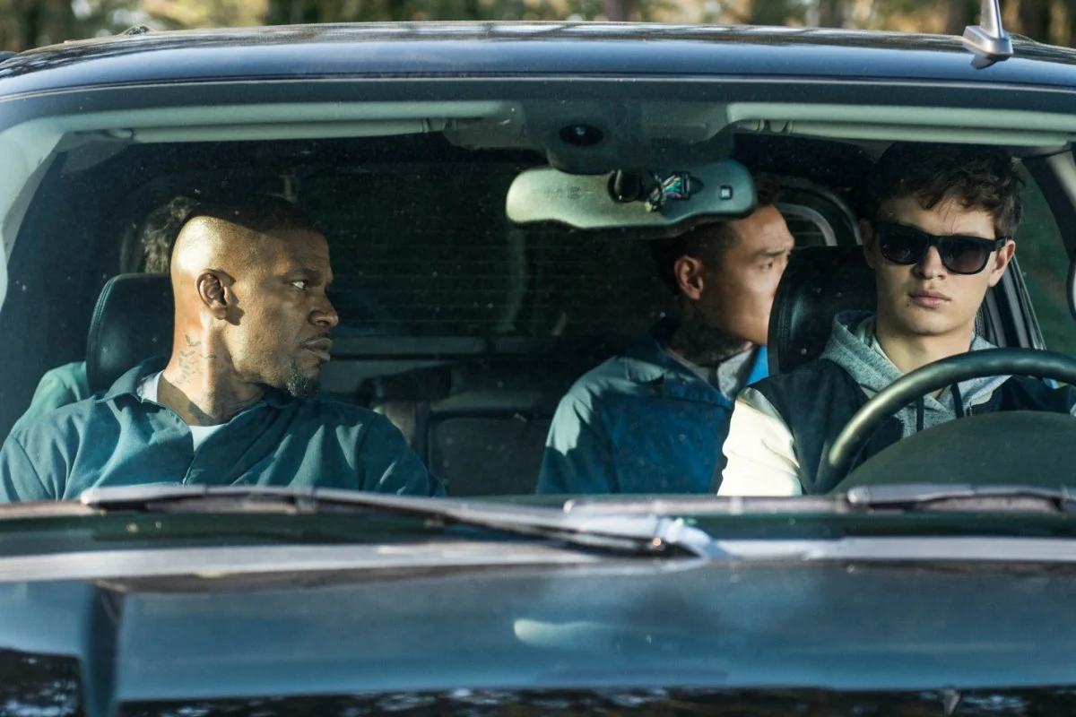 Baby (Ansel Elgort, front right), Bats (Jamie Foxx, front left), JD (Lanny Joon, back right), Eddie (Flea Balzary, back left) wait in the car.