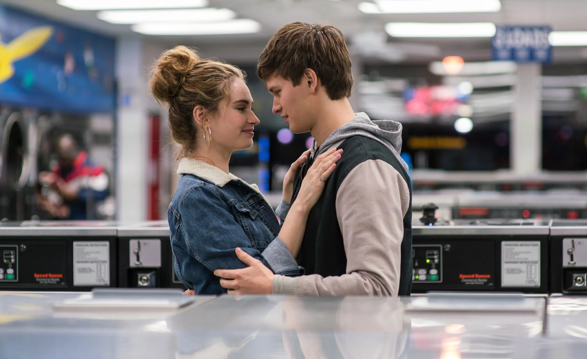 Baby (Ansel Elgort) helps Debora (Lily James) do her laundry as they dance around each other and kiss.
