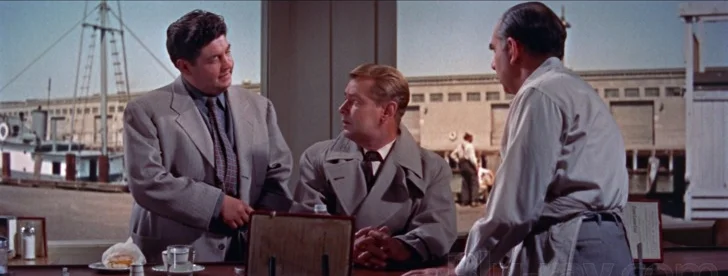 Amato's heavy, Hammy (Stanley Adams), gives the inquisitive Rollins a heavy-handed hint to lay off.
