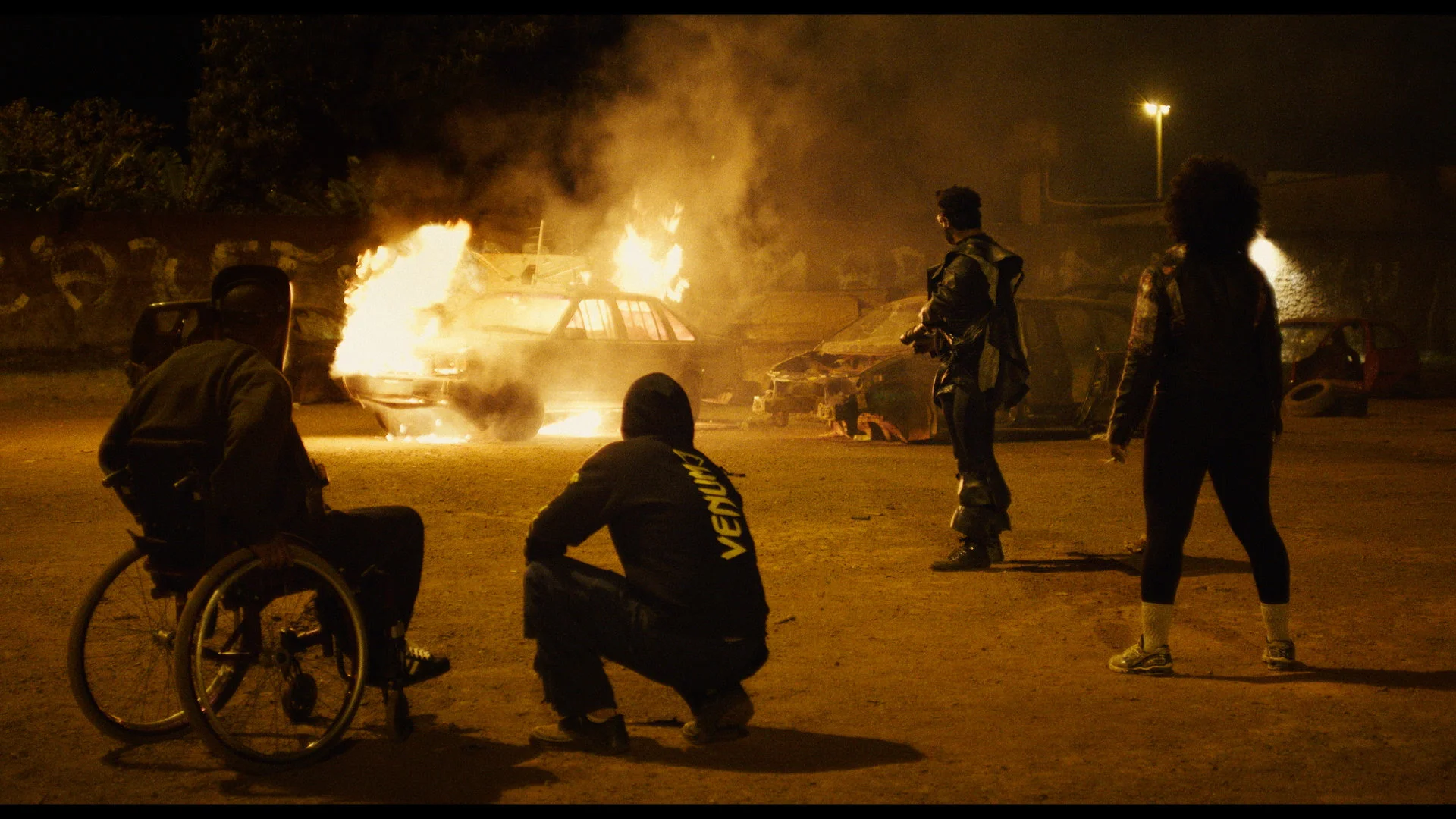 Moment of Catharsis - future warriors burn a car on the site of the spaceship crash