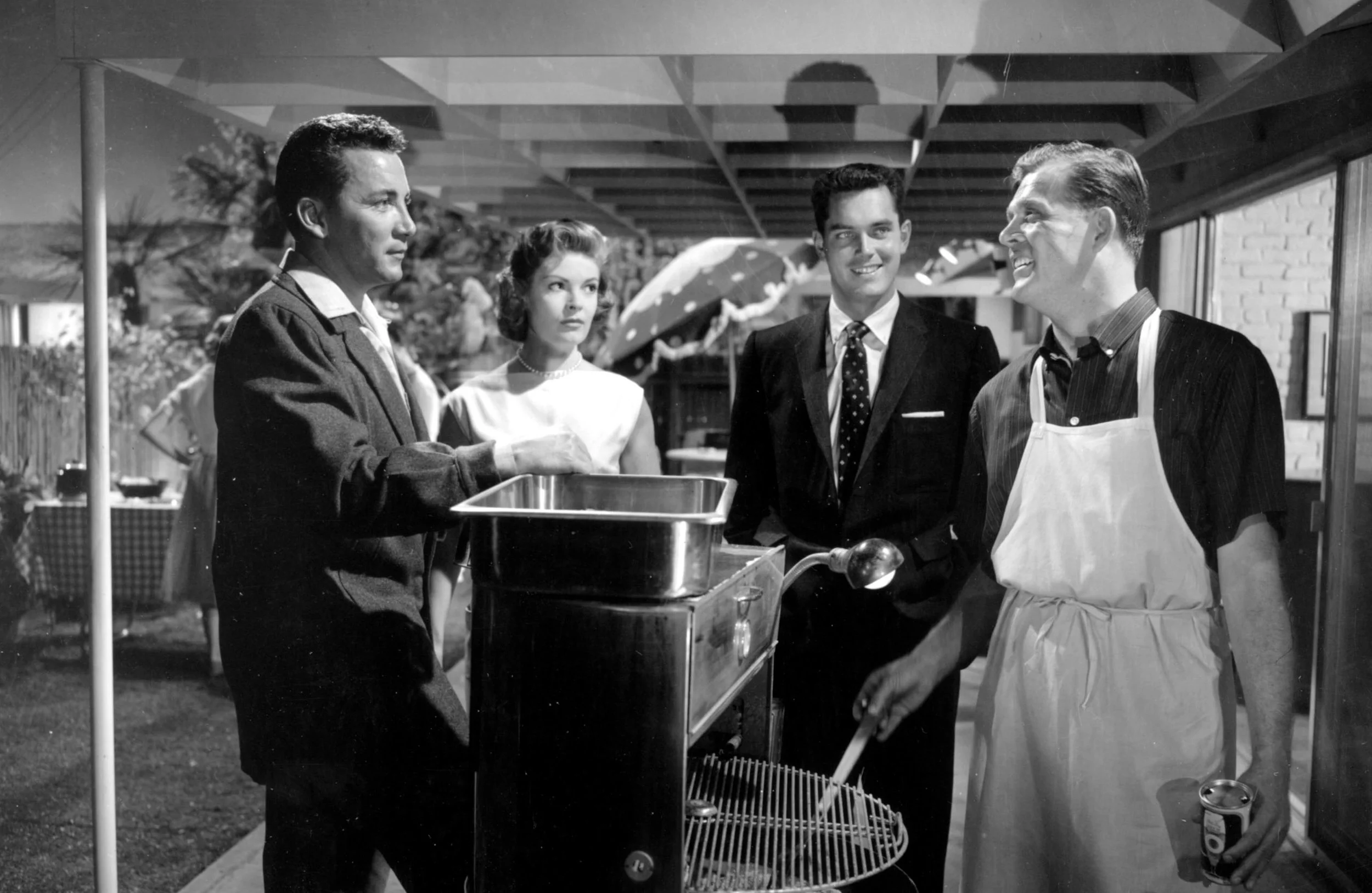 Newcomers in town meet their neighbors at a backyard barbecue hosted by the affable householder (Pat Hingle) behind the grill. 