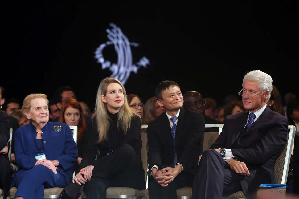 Holmes with Bill Clinton and Madeleine Albright.