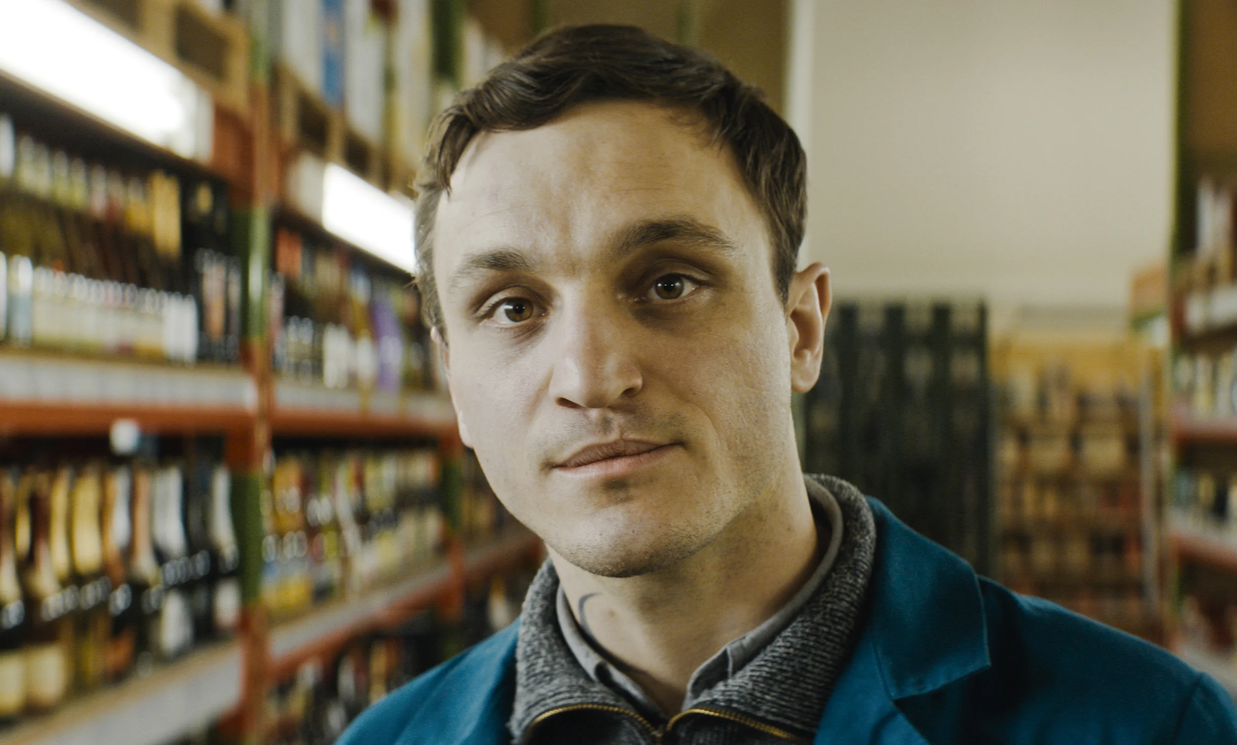 Christian (Franz Rogowski) surveys the night-shift scene in In the Aisles .