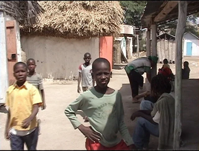 Boys approach me and my distancing camera near where we stayed in Souvnans.