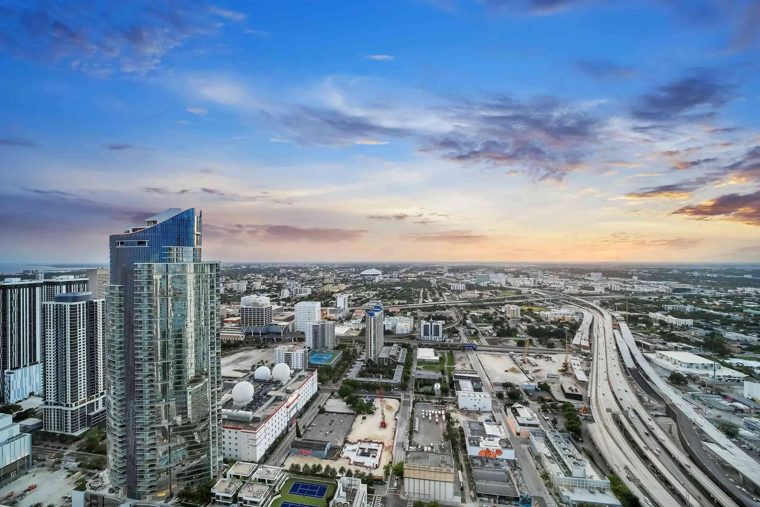 Aerial view of Miami showing high-rise buildings, roads, and surrounding development