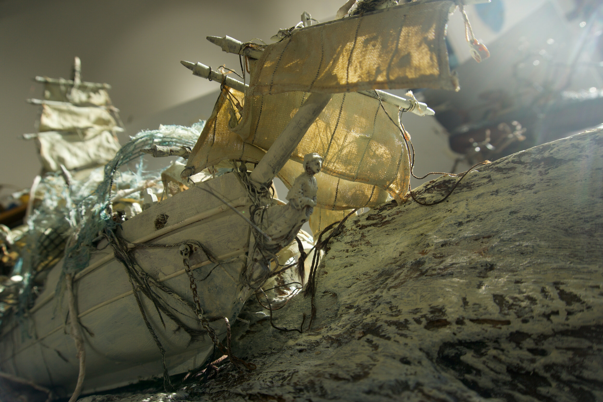 SEAGHOST BOAT: tree bark, found model boat, string, wire, cotton, acrylic paint, unryu paper, ink, canvas 46” x 11” x 20”