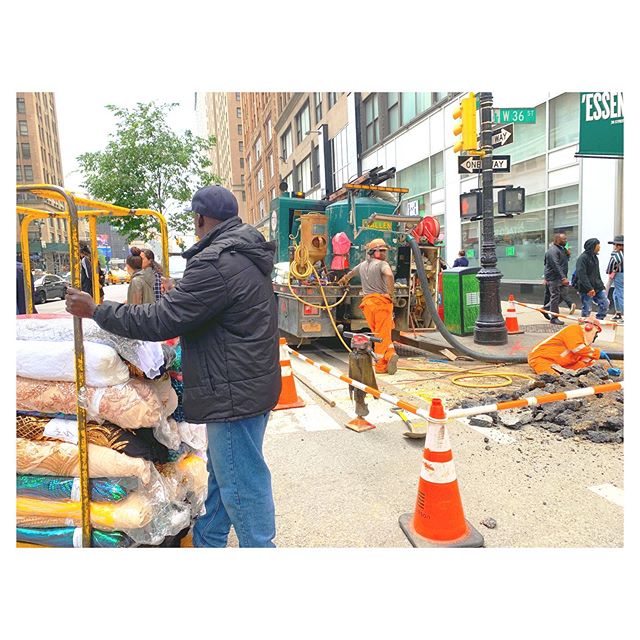 Fancy dress fabric on a hand cart with men at work - the garment district in a nut shell