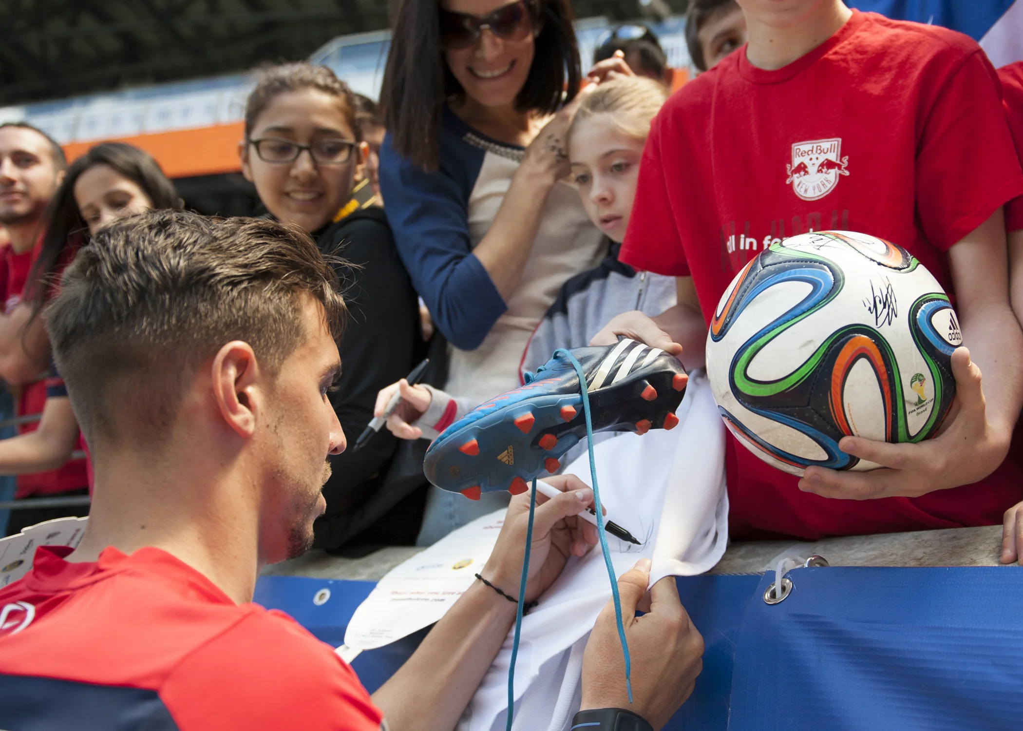 United States defender Geoff Cameron signs memorabilia for fans after the team's open training session at Red Bull Arena on May 31, 2014.