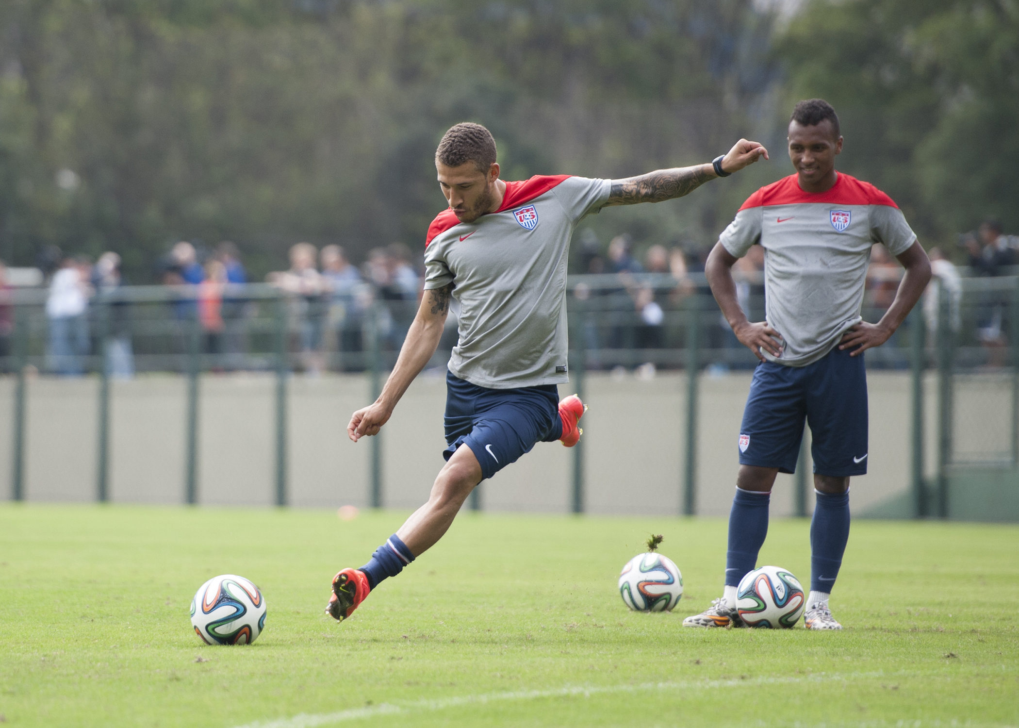 United States defender Fabian Johnson (left) practices free kicks as defender Julian Green (right) watches during training at Sao Paulo FC's training ground in Sao Paulo, Brazil on June 11, 2014.