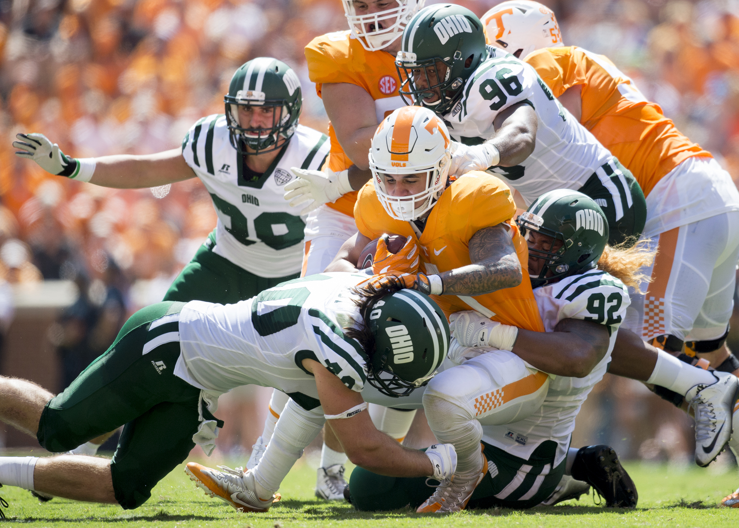 Ohio redshirt junior defensive lineman Cleon Aloese (#92), redshirt junior defensive lineman Kevin Robbins (#96) and redshirt junior linebacker Cody Grilliot (#40) combine for a tackle against Tennessee at Neyland Stadium on Saturday, September 17, 2016 in Knoxville, Tennessee.