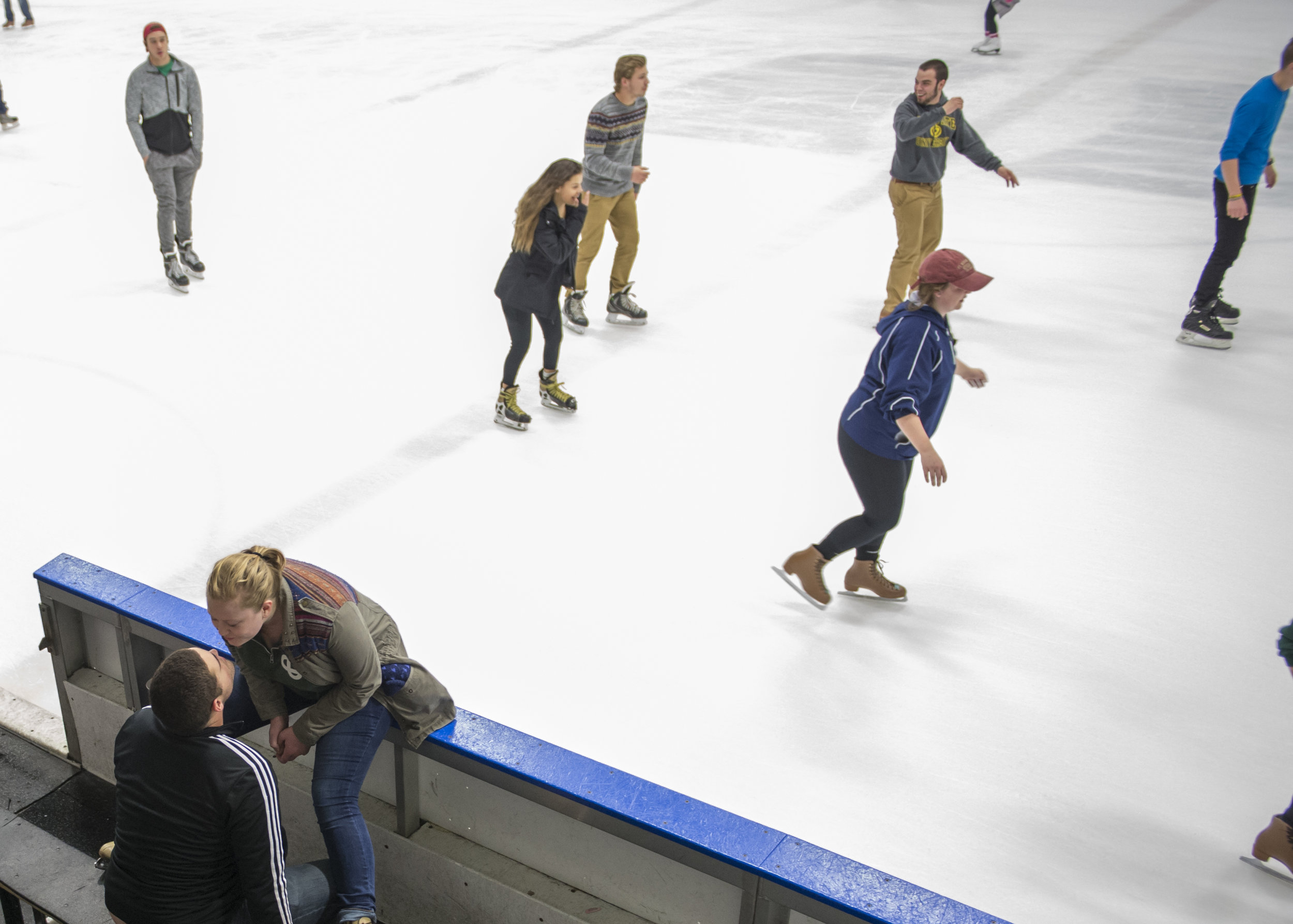   Senior Garrett Birk leans in to kiss his girlfriend Katie Lach while at open skate at Bird Arena. Members of the trombone section often go to Bird to skate together.   