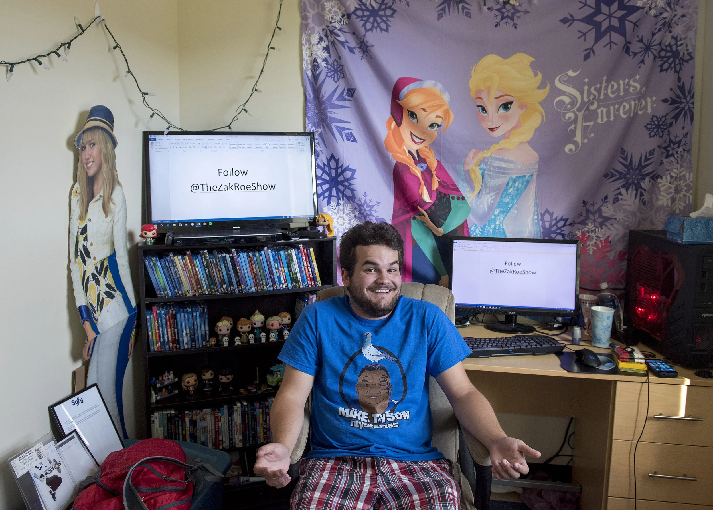 Senior media arts and studies major Zak Roe poses for a portrait in his room in Sowle Hall on South Green. Roe has gained an internet following in recent years following his exploits dressed up as Disney princess Anna from Frozen and walking around campus.