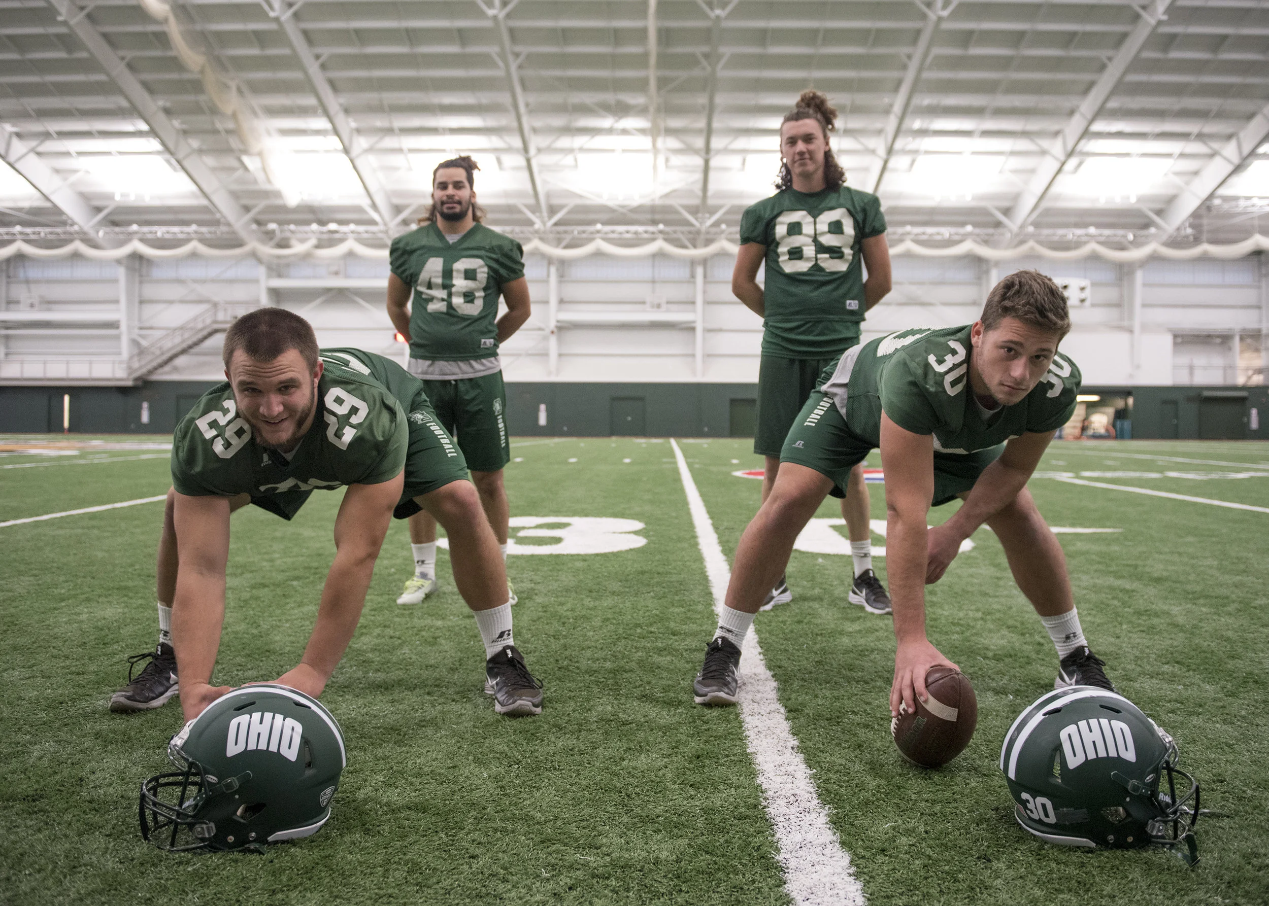 Longsnappers Ceth Miller (front left) and Jake Hale (front right) and kicker Louie Zervos (back left) and punter Michael Farkas (back right) pose for a portrait inside Walter Fieldhouse. Since three of the four are underclassmen, they decided to grow their hair out as a way to bond, although Zervos and Farkas are the only ones left with long hair.