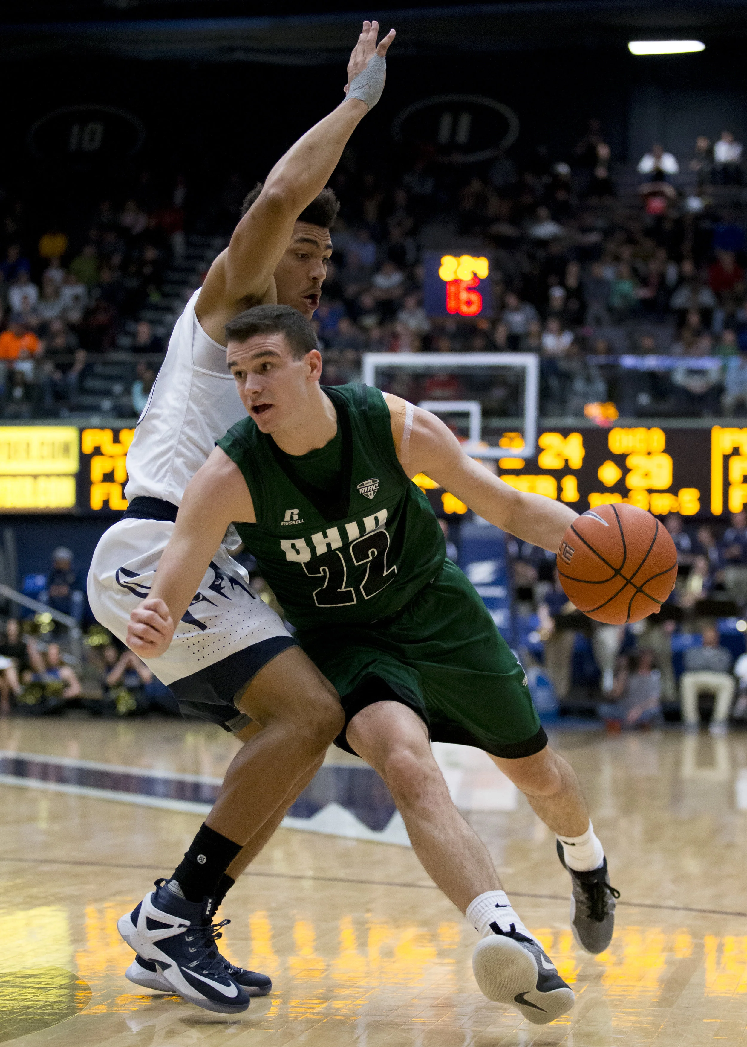 Ohio sophomore guard Gavin Block (#22) drives past an Akron defender during the Bobcat's 83-68 loss at the James A. Rhodes Arena in Akron on January 17, 2017.