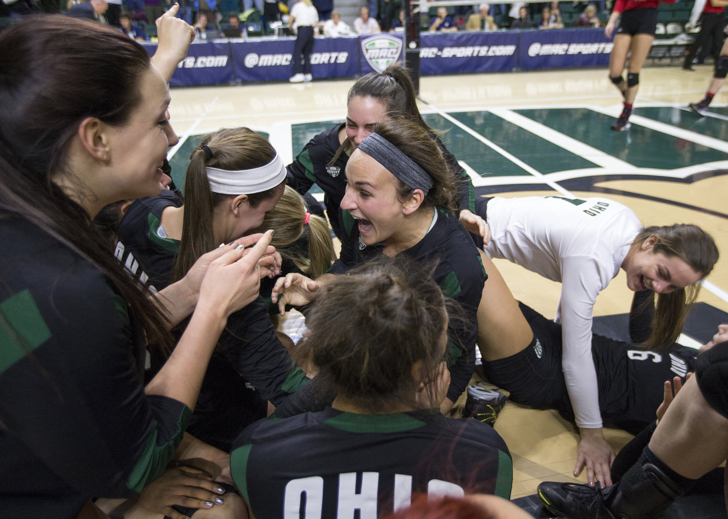 Ohio senior setter Abby Gilleland (center) celebrates with her teammates after sweeping Northern Illinois 3-0 to win the 2015 MAC Volleyball Tournament on Sunday in the Convocation Center.