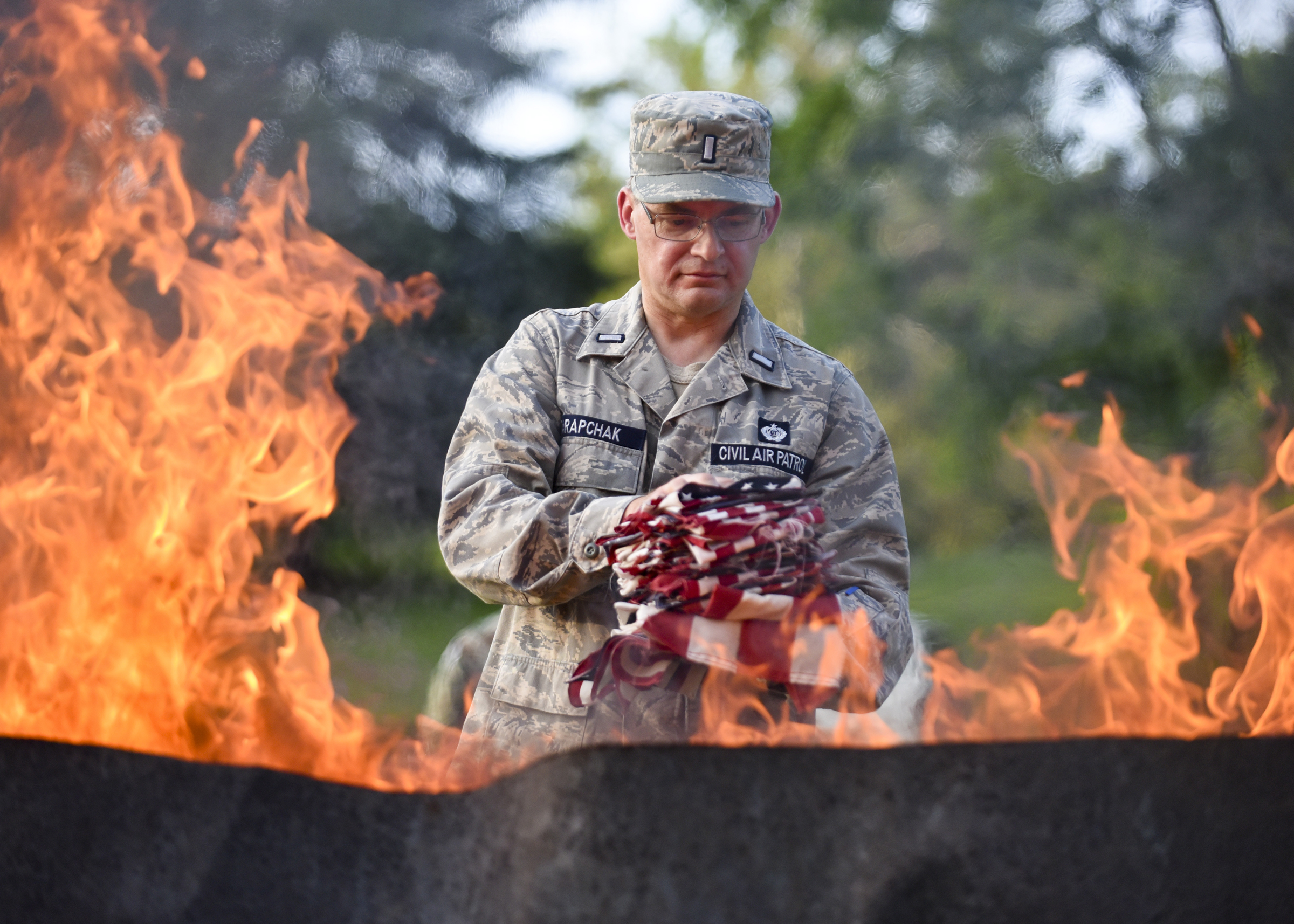 1st Lt. William Tarapchak of Douglasville approaches the fire during a Flag Day flag retirement ceremony at Forest Hill Memorial Park on June 14, 2017 in Exeter Township.