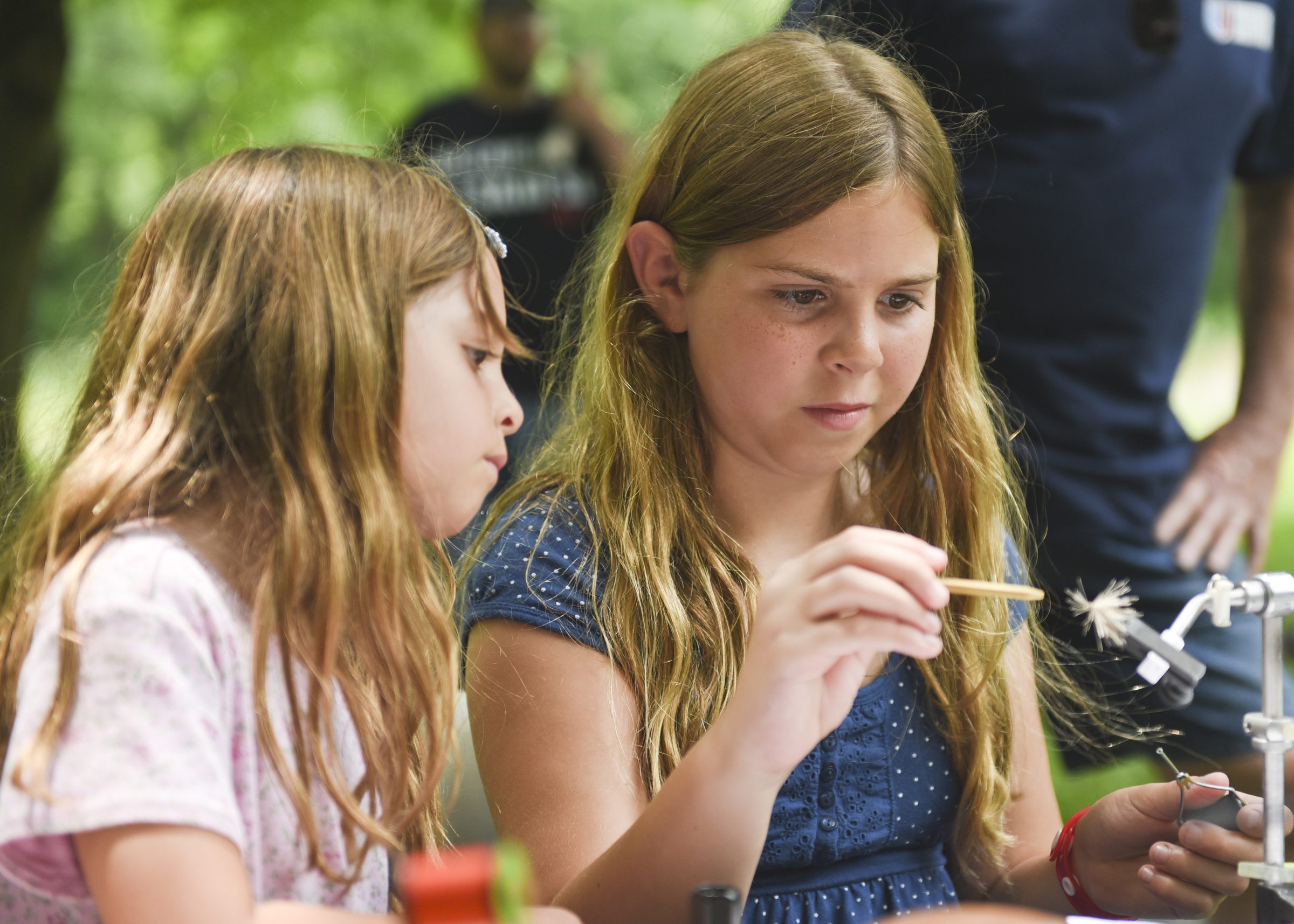 Genevieve Arena, 10, of Hamburg learns how to make a fly while her sister Joscelyn, 6, looks on during a fly fishing tutorial hosted by the Berks Fly Tyers Club at the Berks County Heritage Center on June 18, 2017.