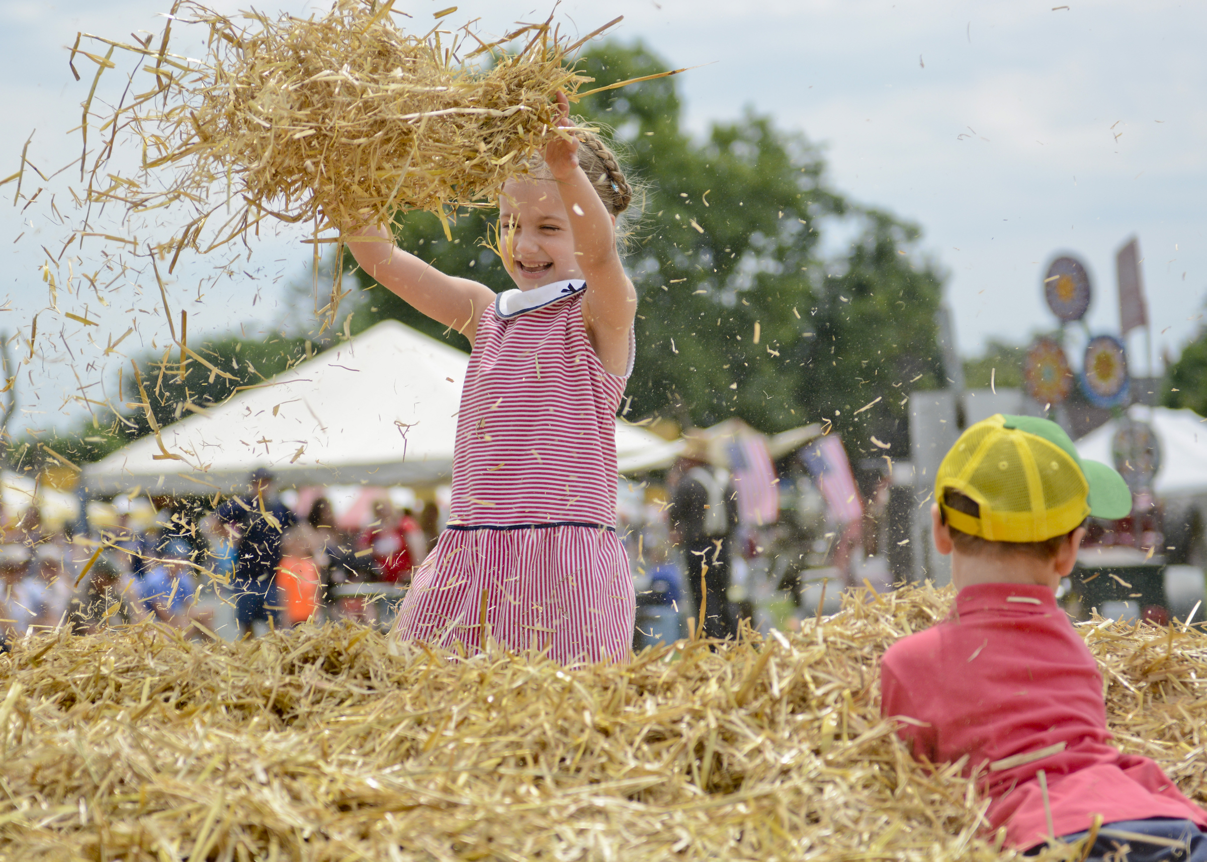 Veronica Steele, 6, and her brother Julien, 3, both of Allentown play in the hay at the Kutztown Folk Festival on July 4, 2017.