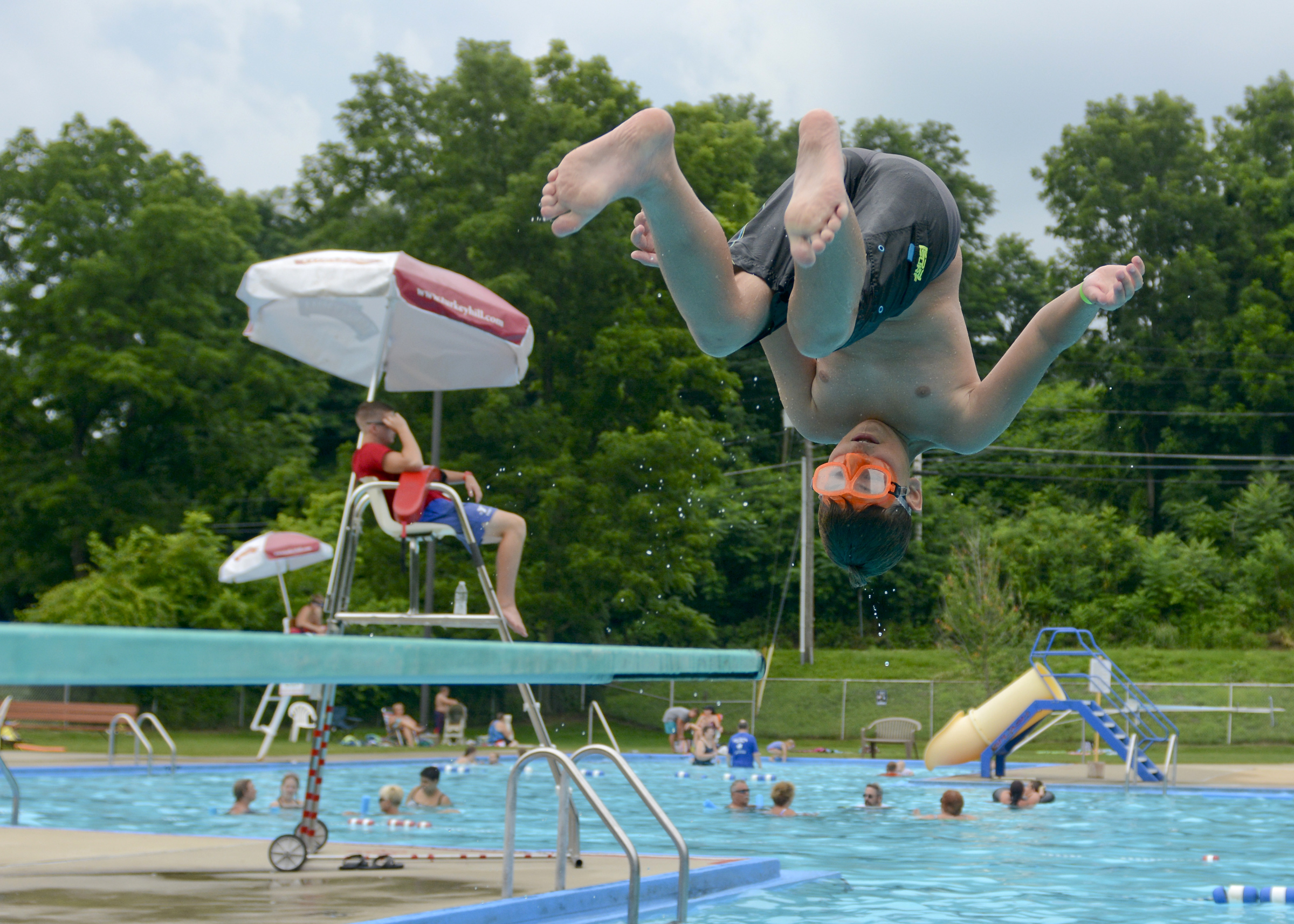 Pasquale Perrotta, 10, of Myerstown does a front flip off the diving board at the Womelsdorf Swimming Pool on July 13, 2017.