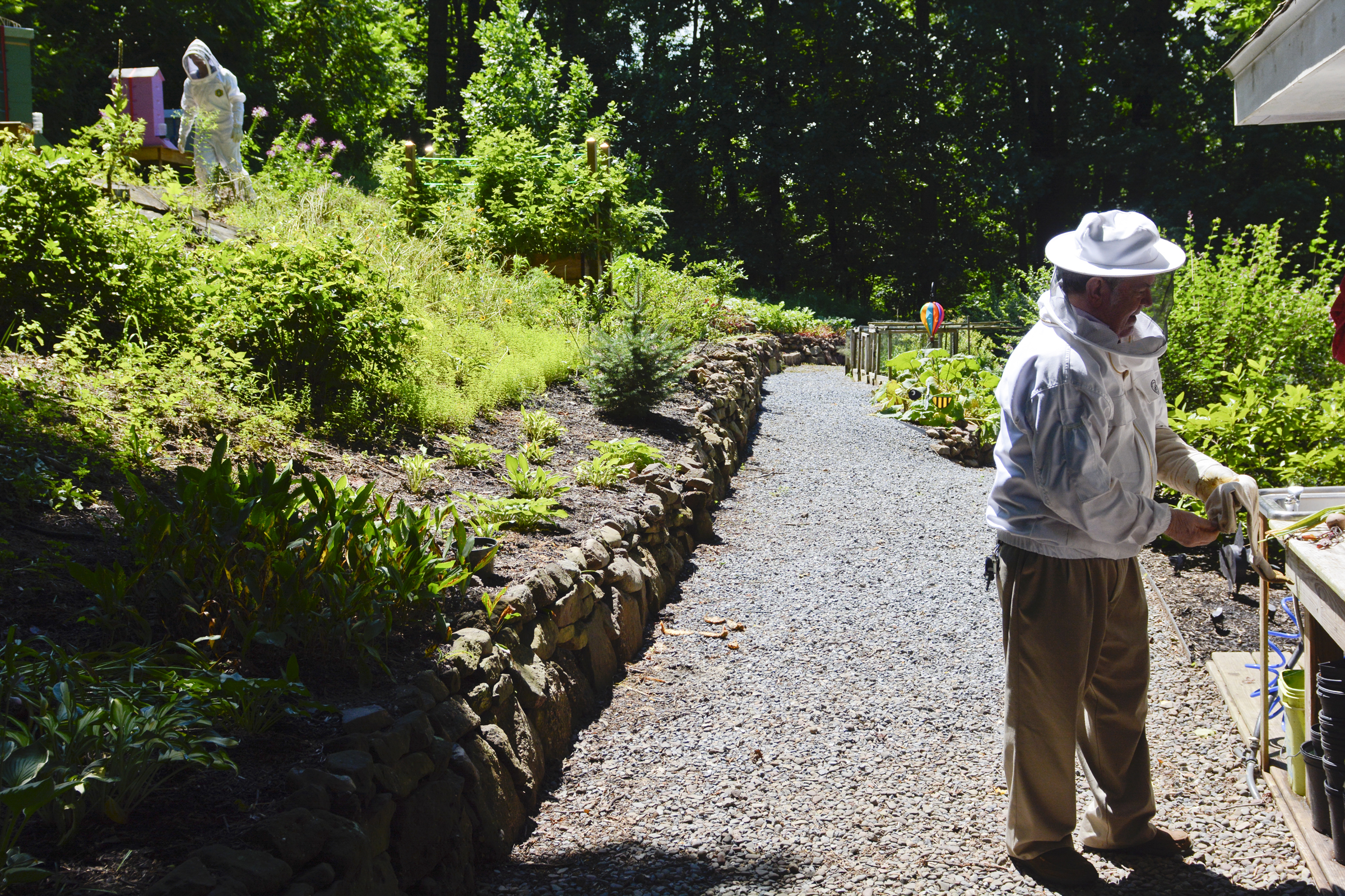 Steve Fellman and his godson Nicolas Ciabbatoni, 15, of Exeter Township get ready to work on the beehives at the Fellman's garden in Cumru Township on July 25, 2017.