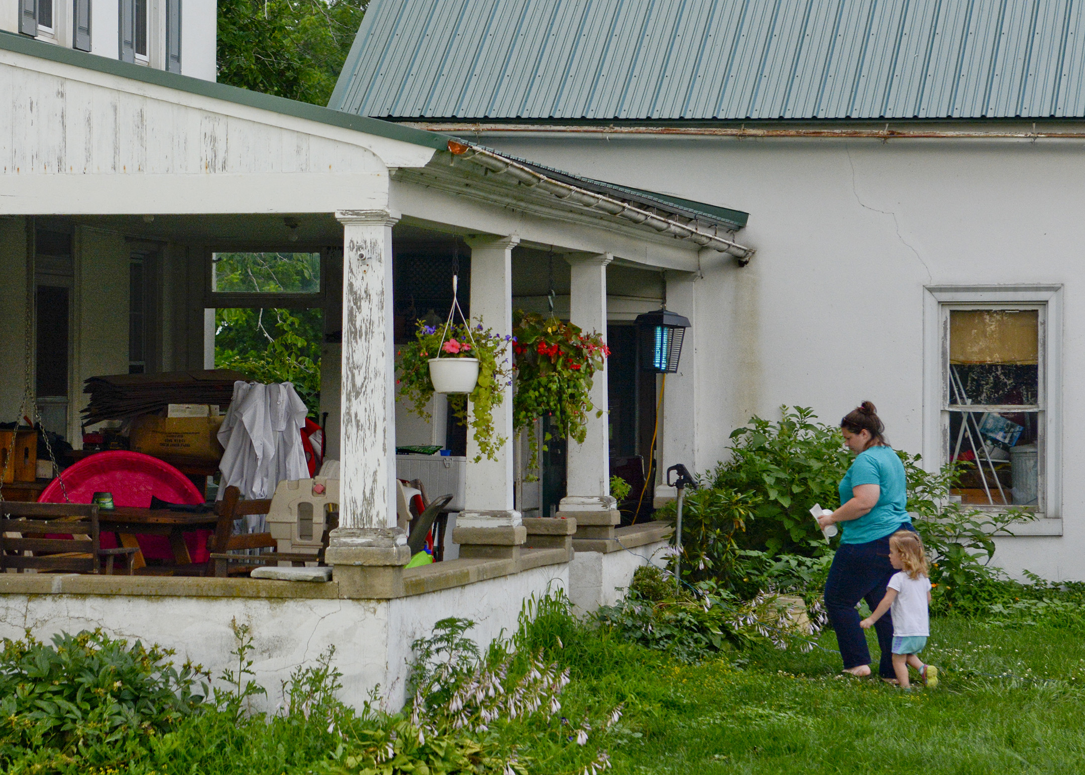  Jodi Gauker and daughter Callie, 2 1/2 of Fleetwood walk into their house at the Gauker Family Farm in Fleetwood on July 18, 2017. 