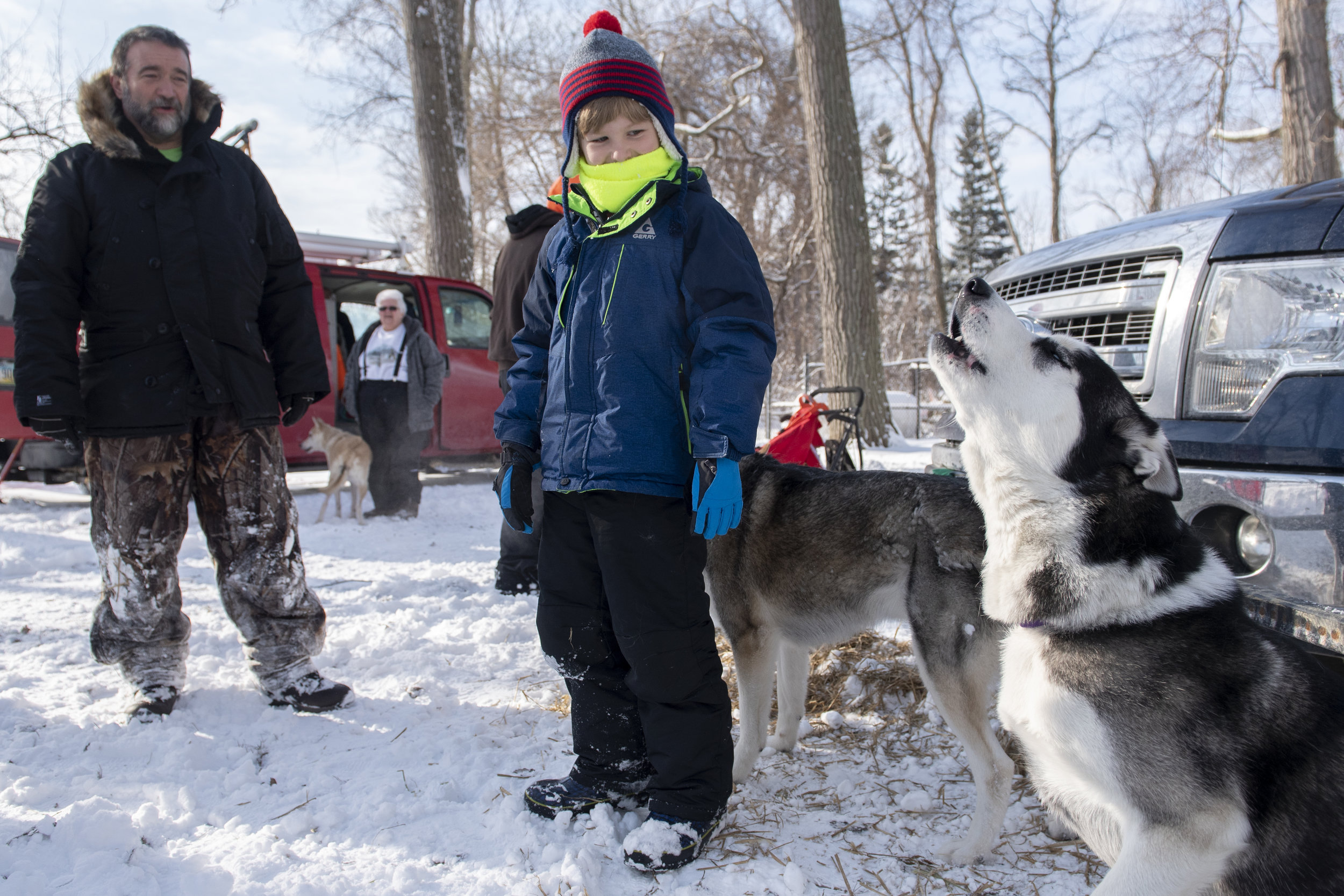 Jacob Owens, 9, of Fairview, PA, looks on as Zoey the husky (part of the Trail Breakers Sled Dog Club) howls at the 5th Annual Presque Isle Snow Day on January 26, 2019. Jacob was there along with his mom, Monica, also of Fairview, for their first v