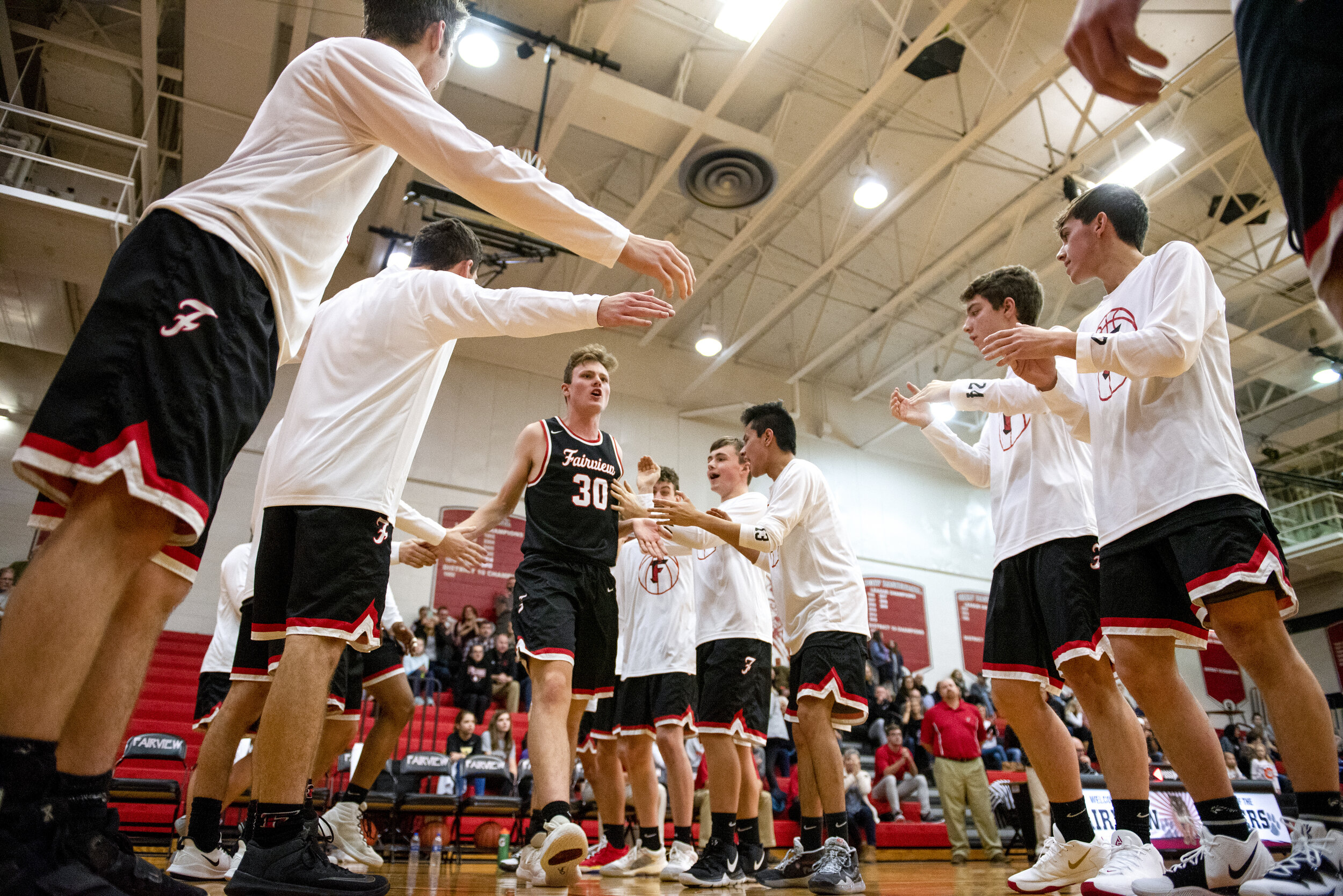 Fairview High School senior forward Phillip Thiem (#30) high-fives his teammates as he is introduced before the start of the Tigers’ game against Erie High School on December 7, 2019 at FHS.