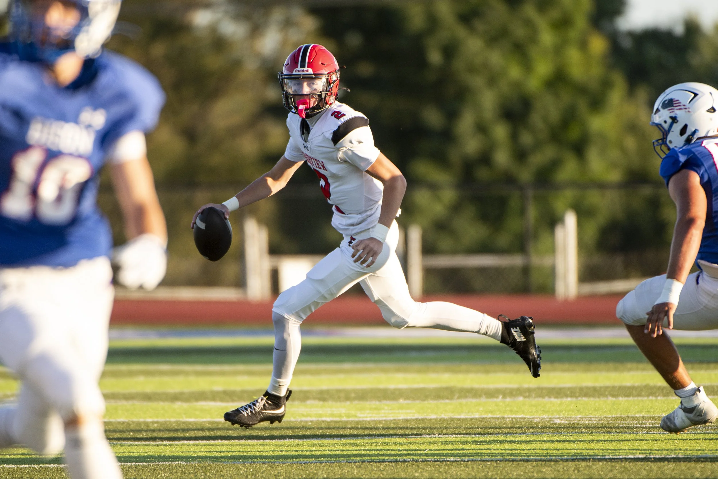  Fairview junior QB Cullen O’Conner (#2) escapes from the pocket during the 1st quarter of the Tigers’ season-opener against the Fort LeBoeuf Bison on August 28, 2026 at Carm Bonito Field in Waterford, PA.  