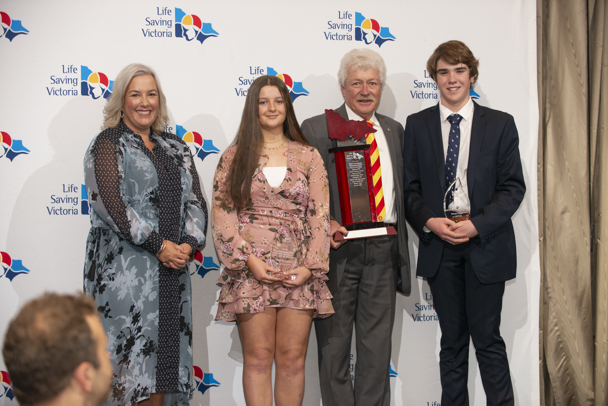 Ruby Lines-Perrier, second from left, with co-winner Samuel Dripps, from Jan Juc Surf Life Saving Club, membership and leadership development director Angela Malan, and Mike Martin.
