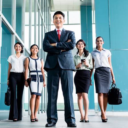 37779454-asian-business-team-of-executives-very-determined-to-find-some-fault-in-the-books-they-will-do-revis.jpg
