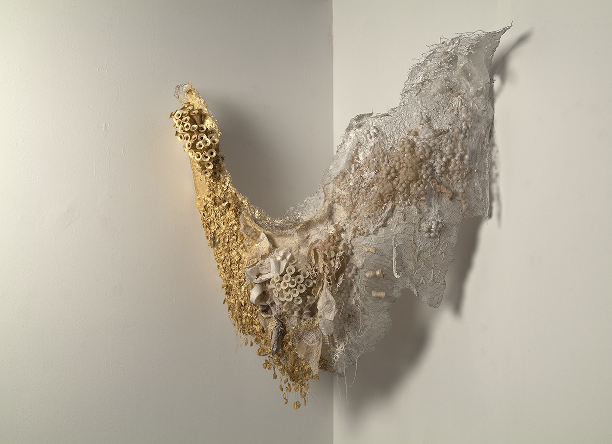   Hybrid (gold) , 2017, handmade paper, found objects: cocoons, hairnets, gold pigment, rawhide bones, wire armature, 60” x 120”    