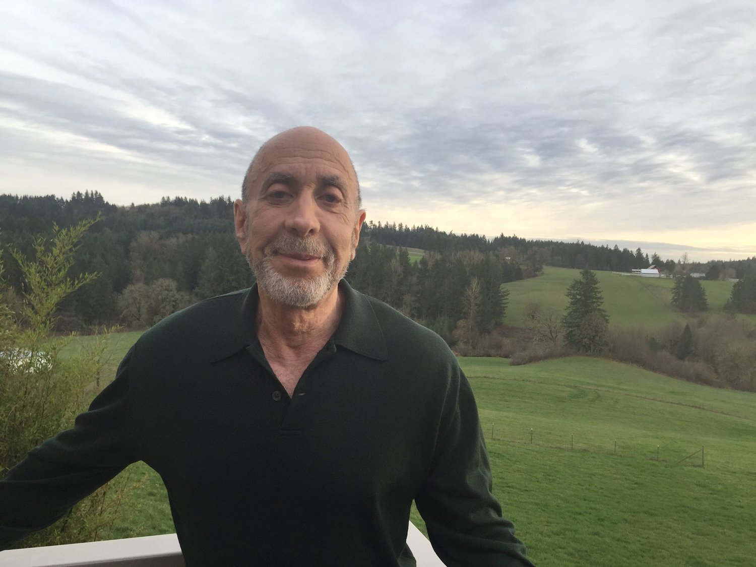 Daniel Goldstein standing in front of a sweeping landscape