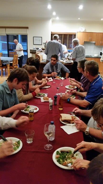 Local members and MYM members sharing a meal