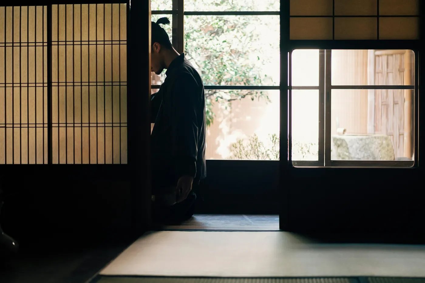 person sitting alone window light Japan Zen