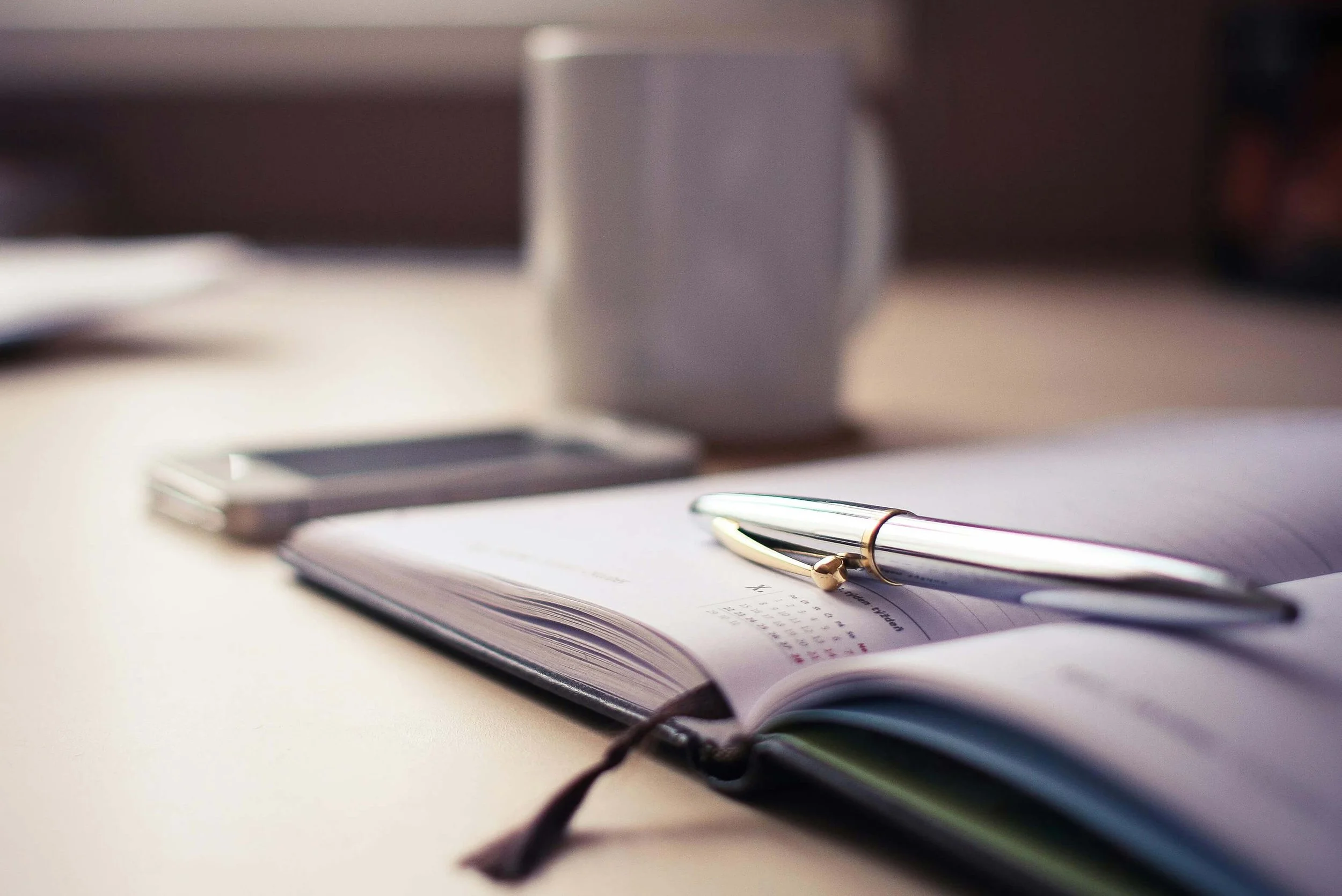 Silver Click Pen on Open Book