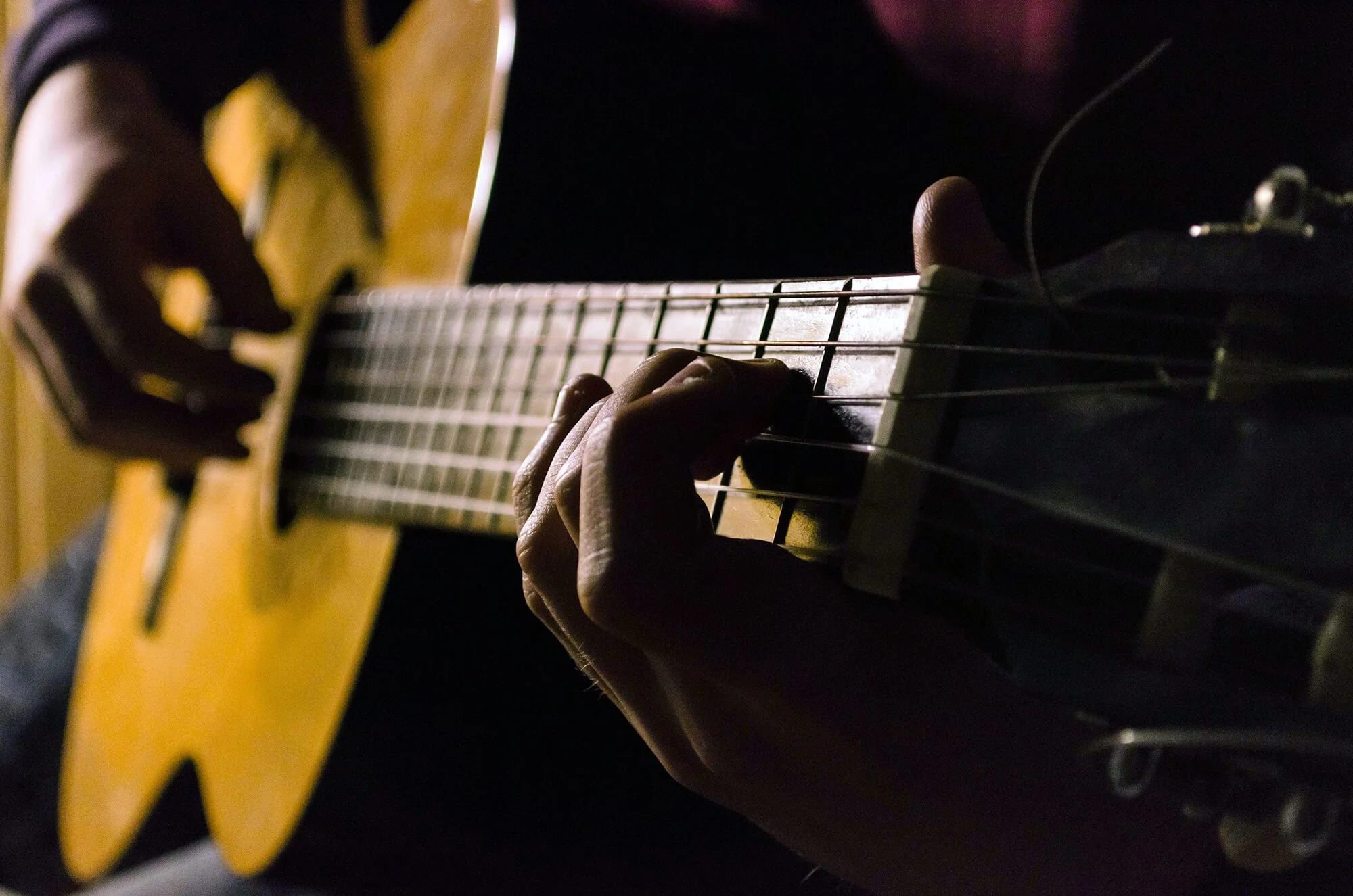 A Musician Playing the Acoustic Guitar