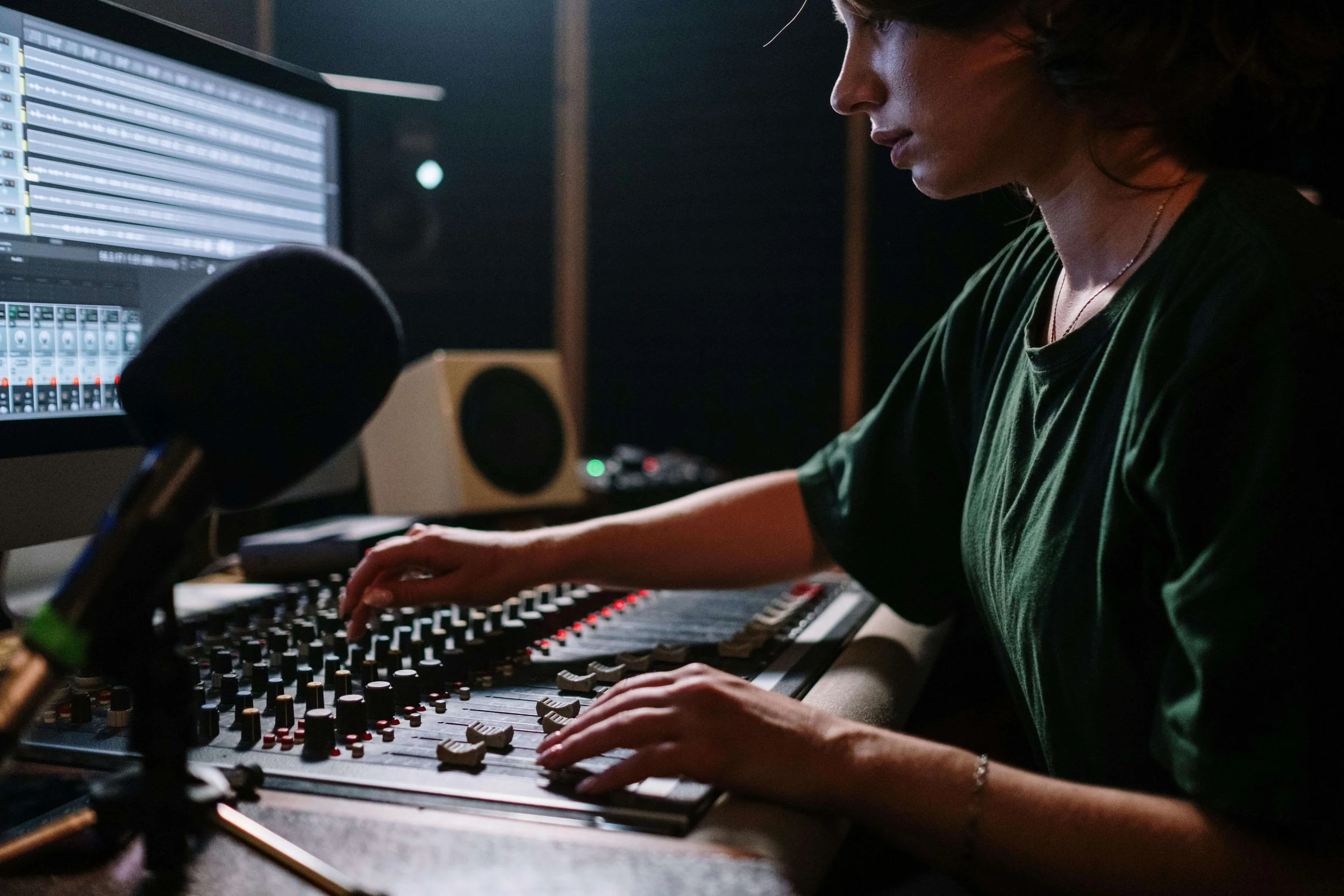 Woman Sitting by Sound Mixer and Working