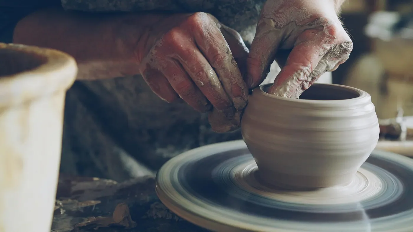 hands making ceramic bowl close up