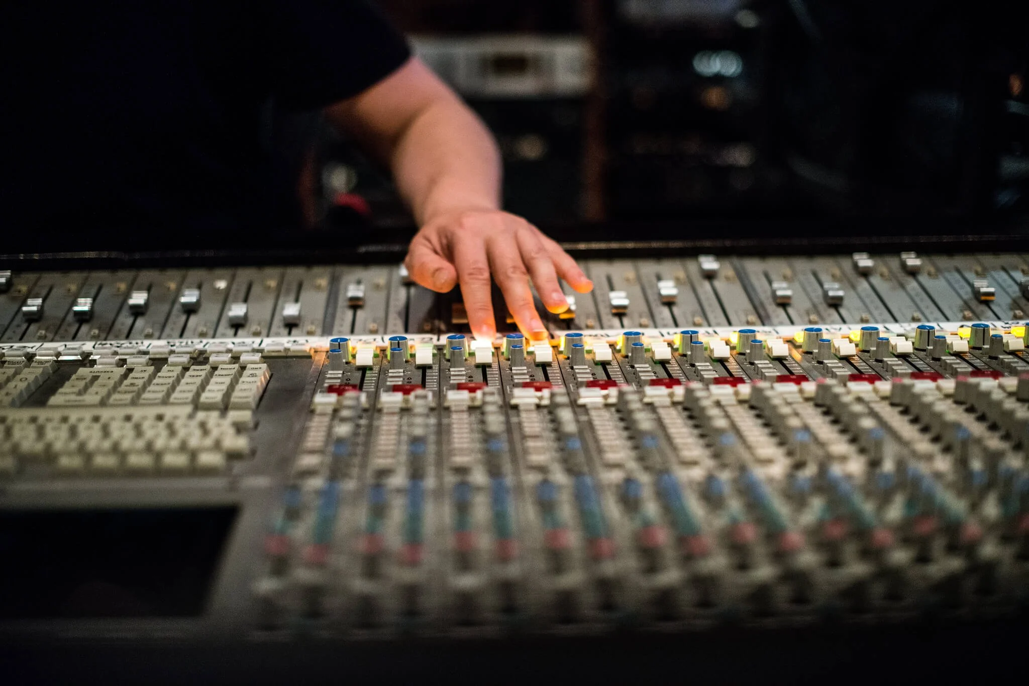 Hand on mixing console fader