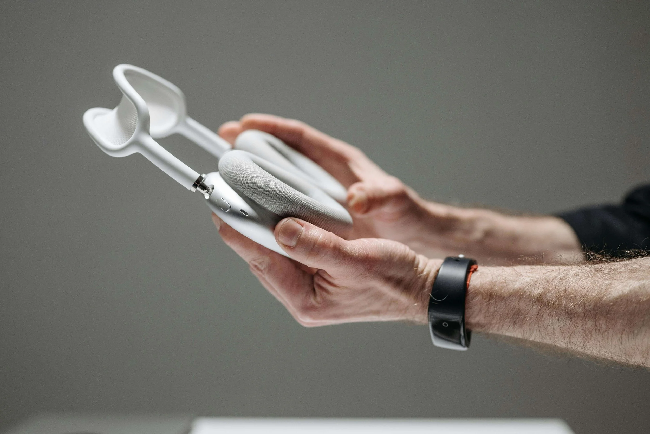 A Person Holding Wireless Headphones