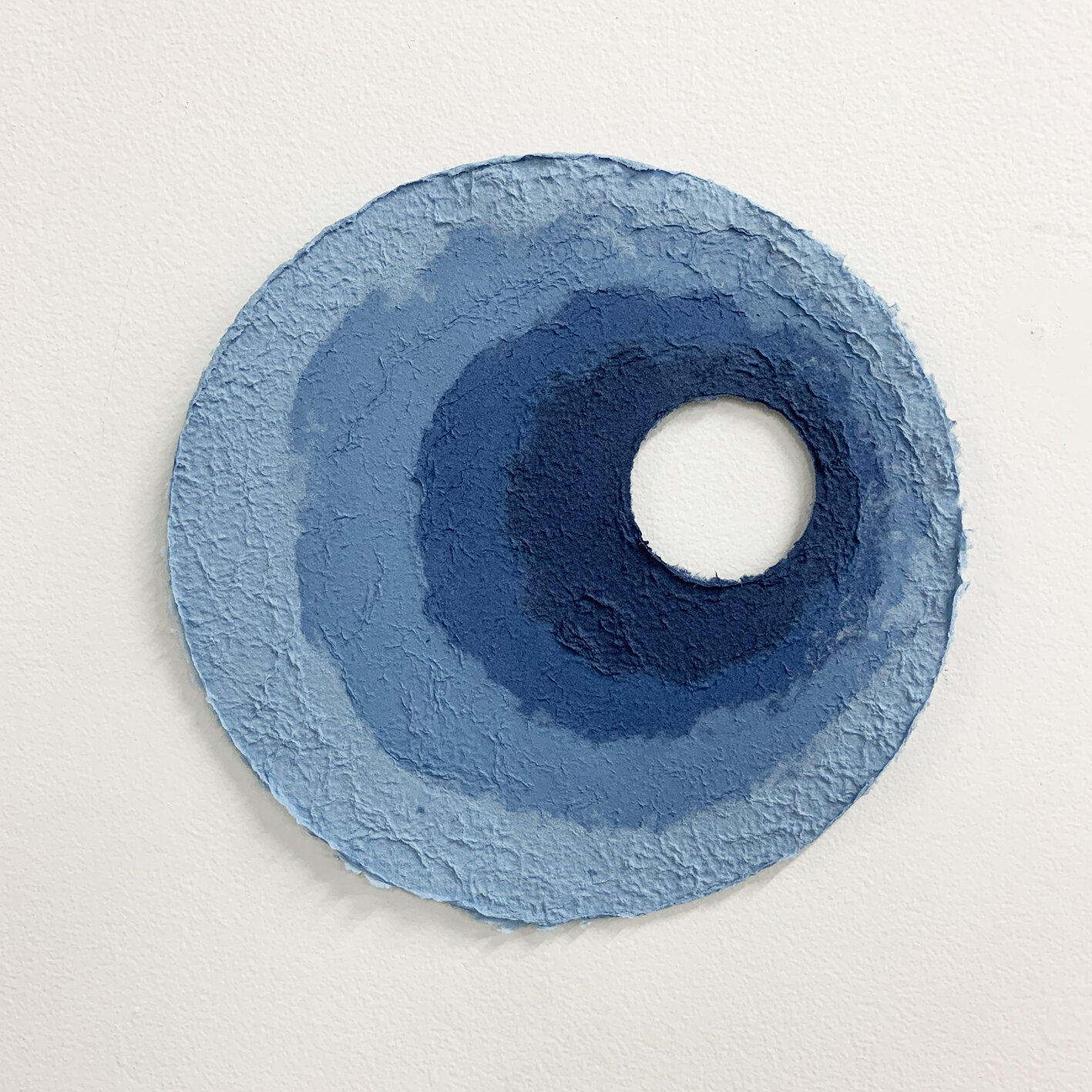    Softest hard  #5,  2020.   Hand-made paper, from indigo-dyed salvaged textiles (cotton bedsheets). 40cm x 40cm 