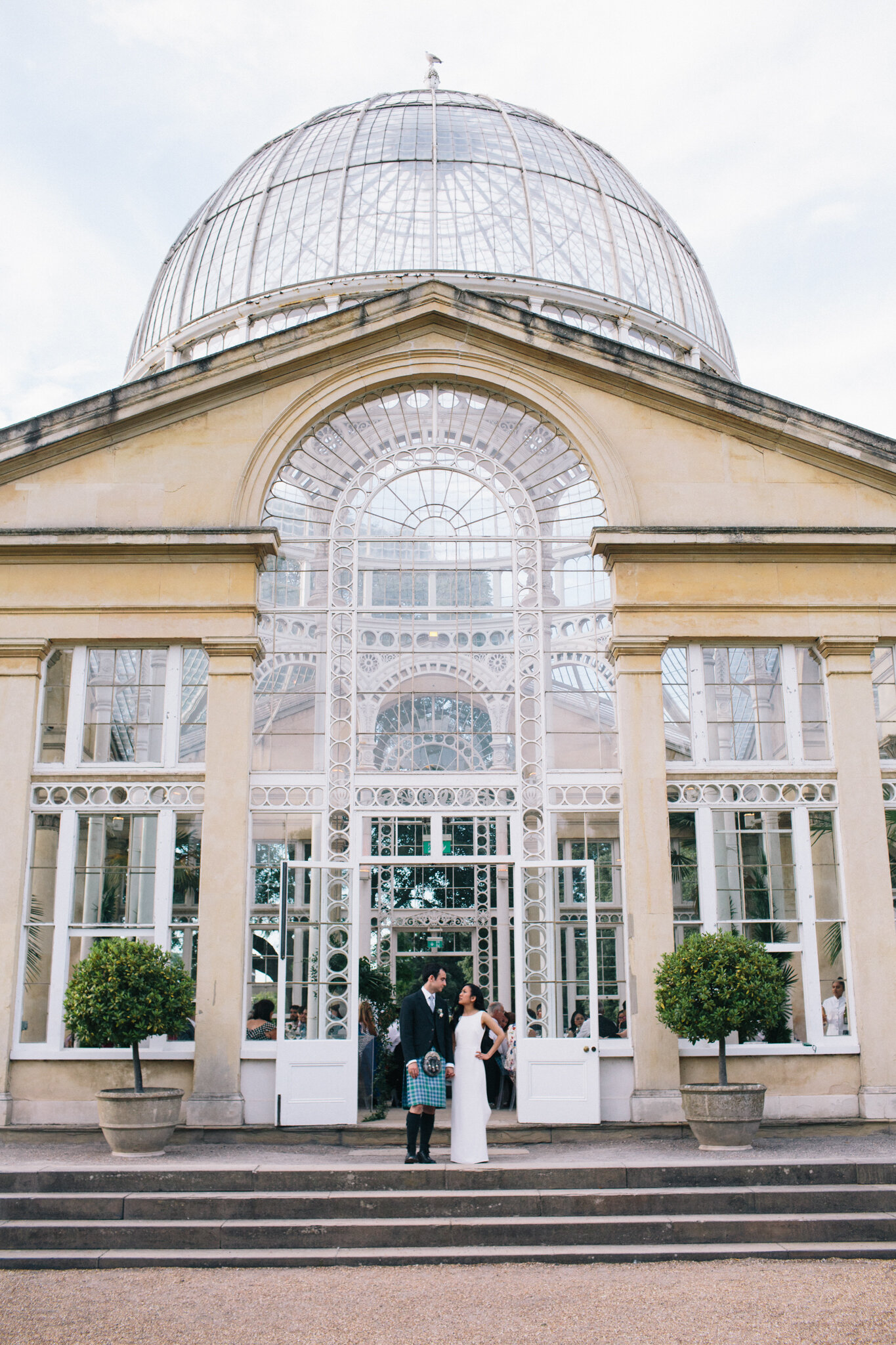 Bride and groom standing outside Syon Park Wedding venue