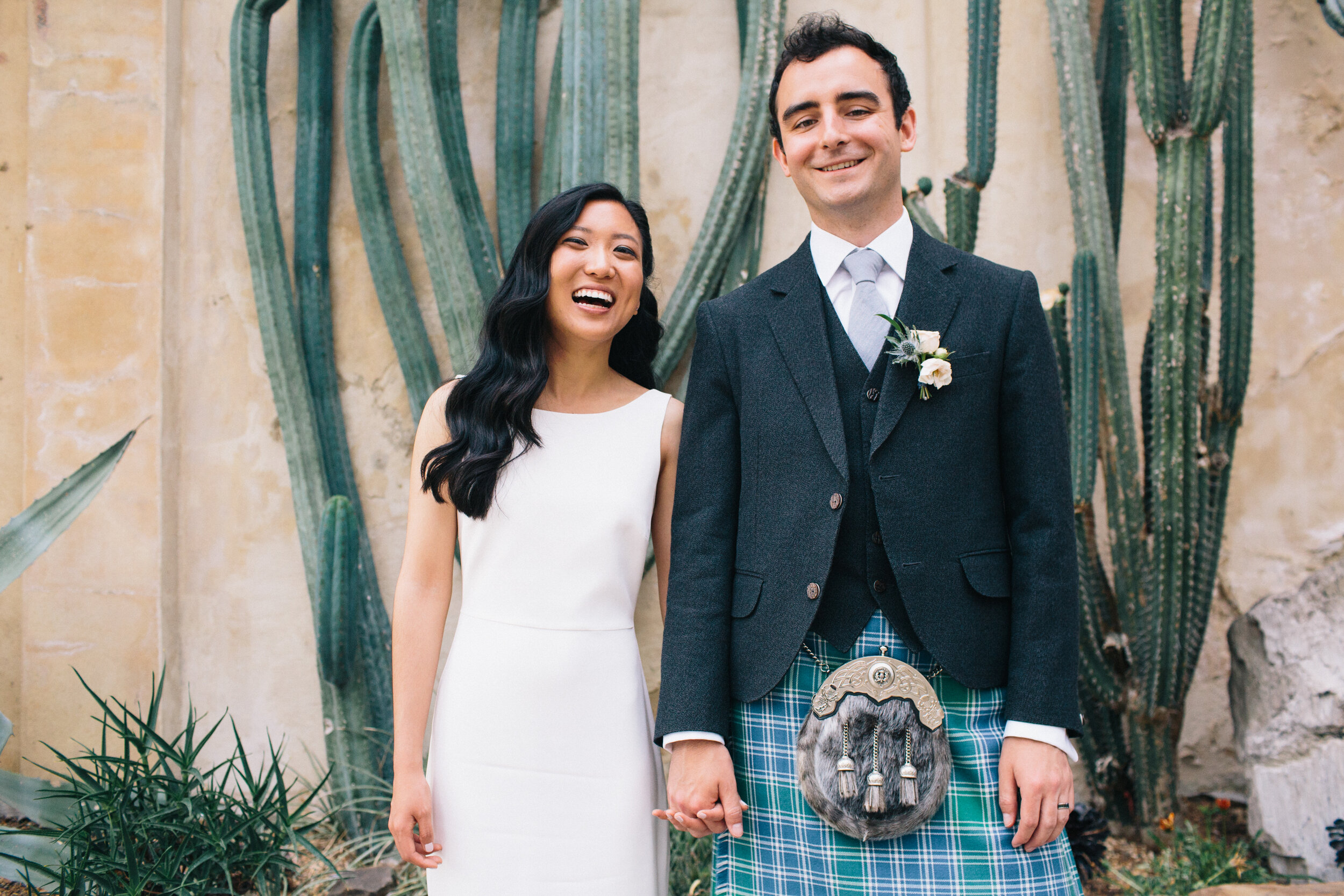 Bride and groom laughing with cactus at Syon Park