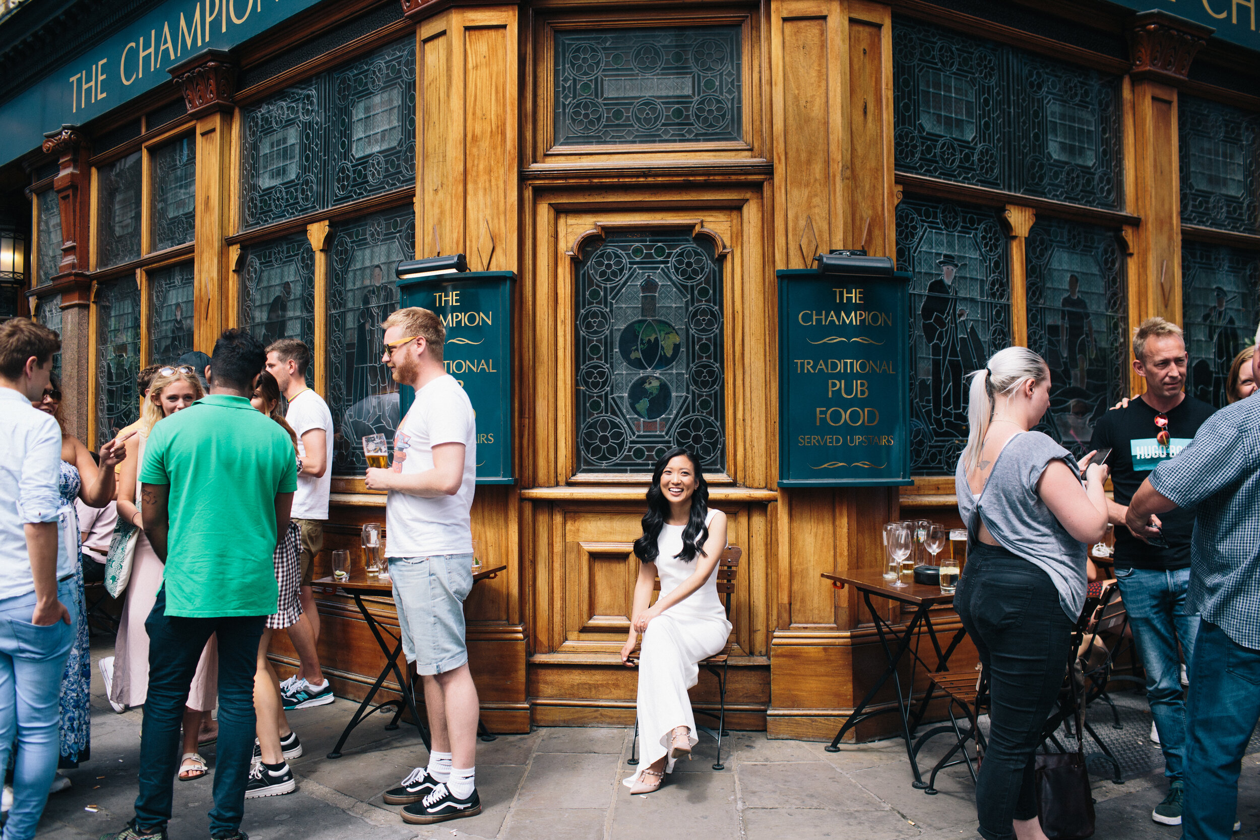 Bride sitting outside a soho pub